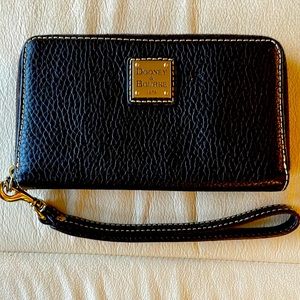 Dooney & Bourke Black wallet with removable wrist strap. Cream stitching